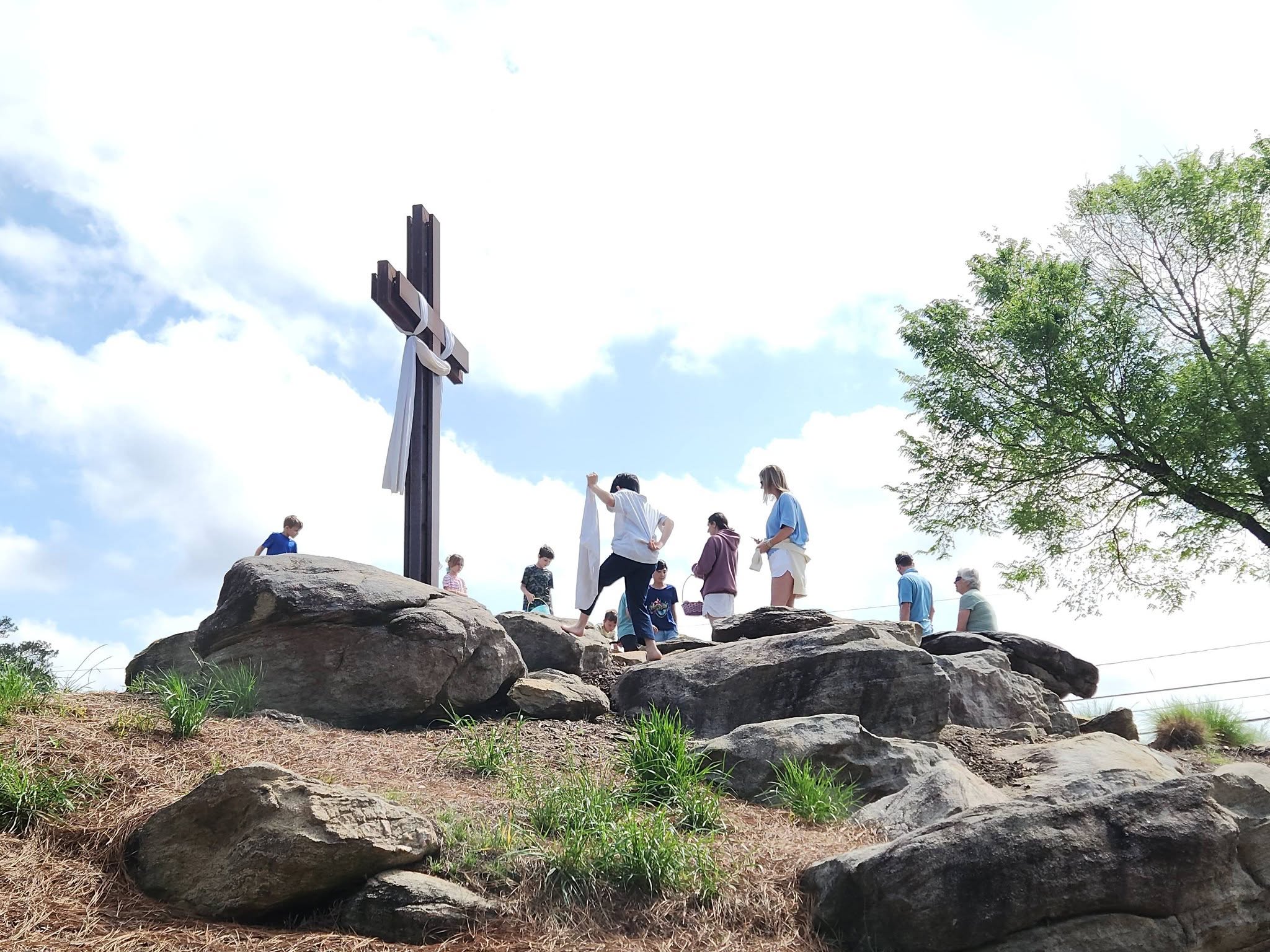 The congregation gathered on the rocks around the dressed cross on Easter morning