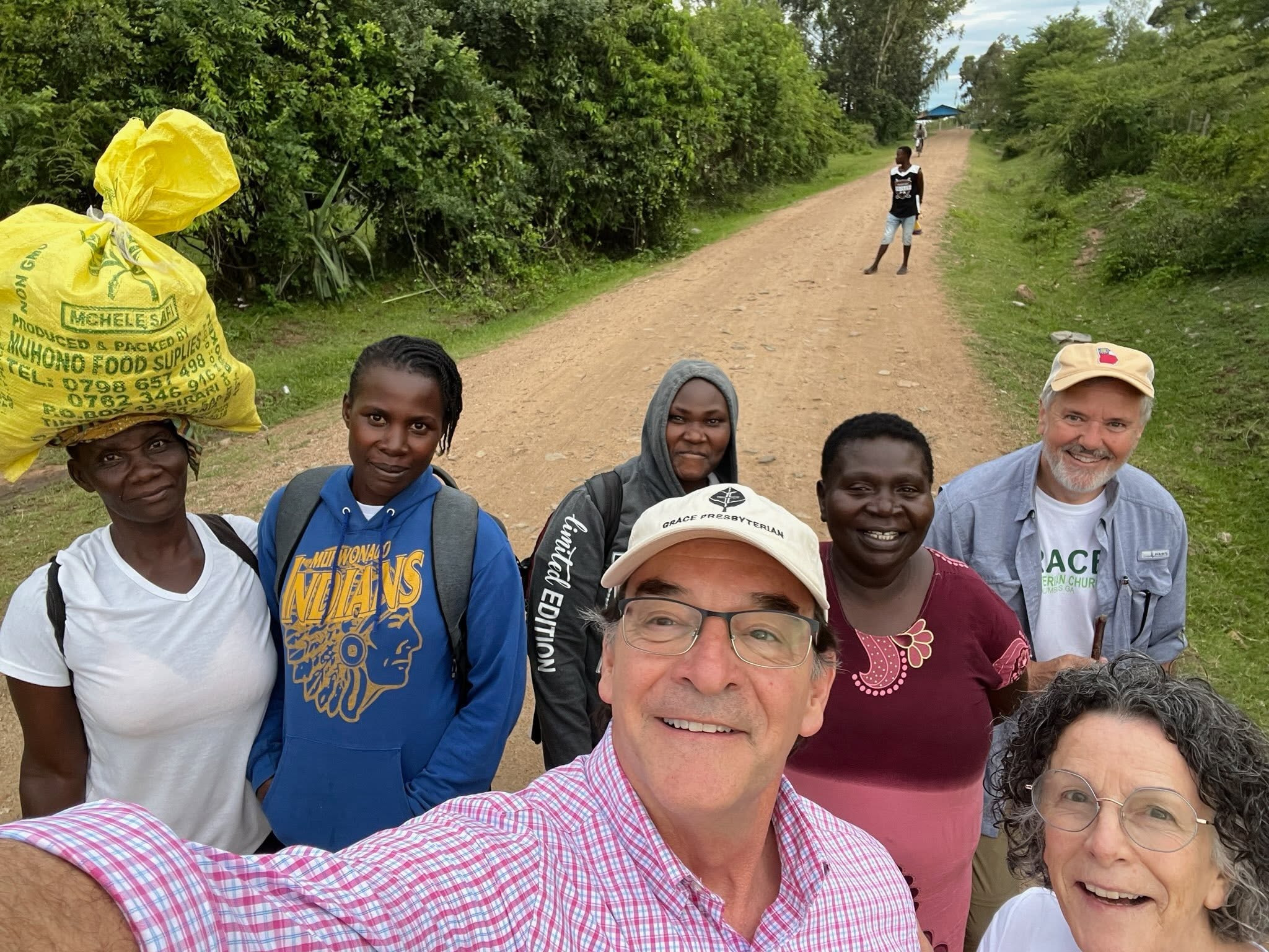 Grace members walking the dirt road to the Wachara school with Kenyan partners