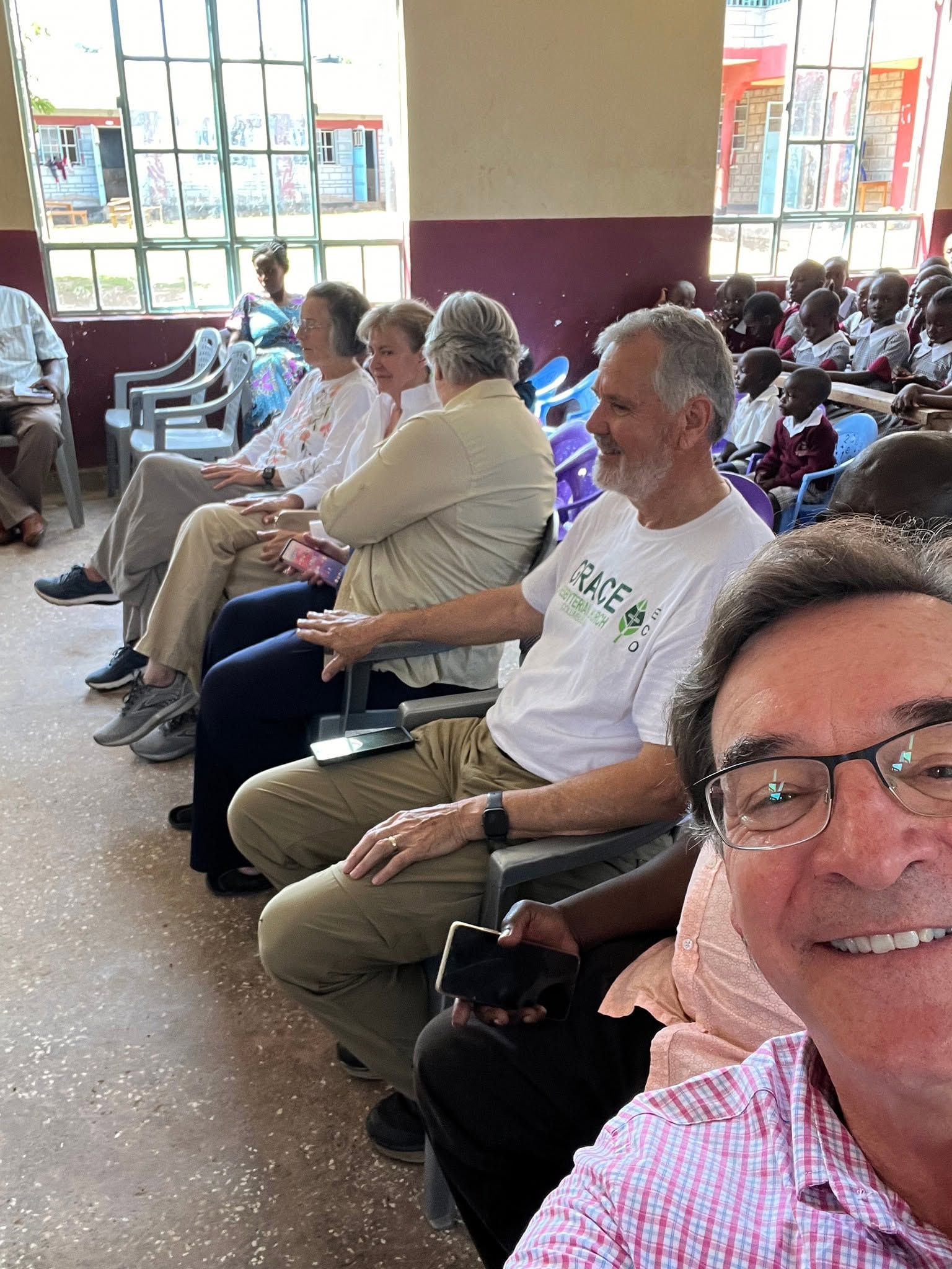 Grace members among students in the Wachara schoolyard