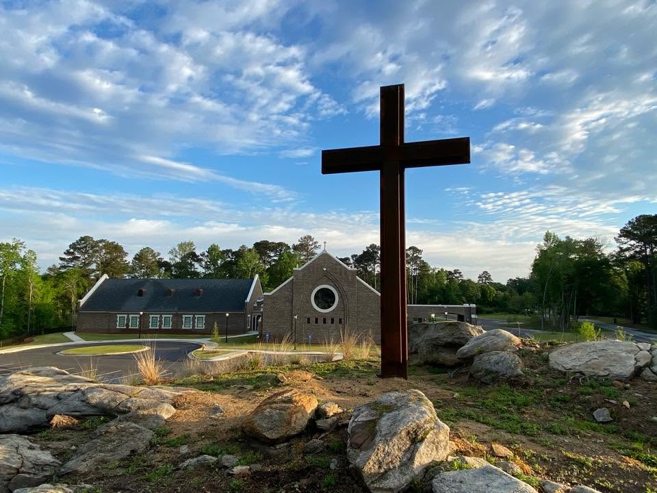 The land, the stones, and the cross before the sanctuary
