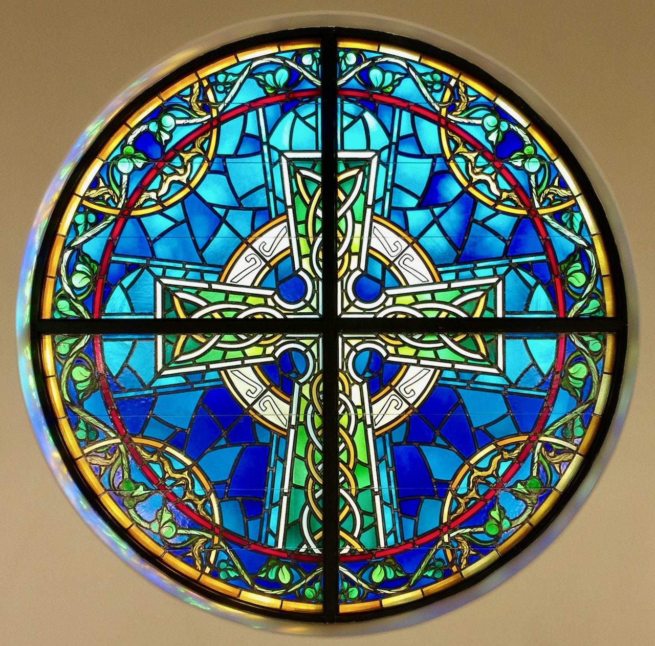 Grace's rose window: a Celtic cross in cobalt, cyan, green and gold